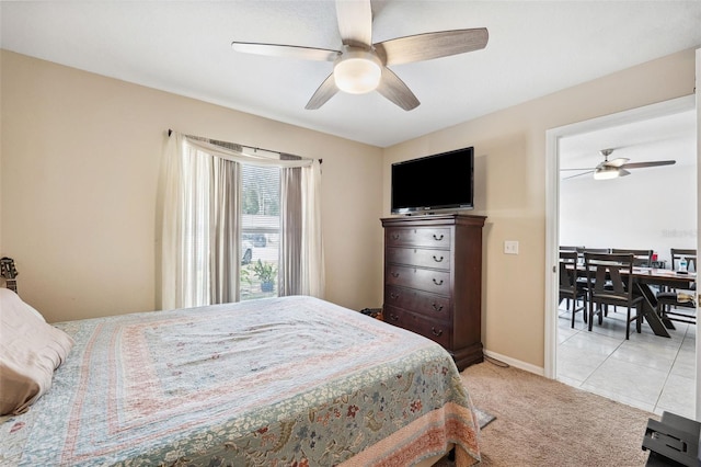 bedroom with tile patterned flooring, baseboards, a ceiling fan, and carpet flooring