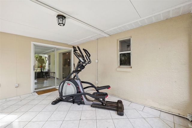 exercise area featuring light tile patterned floors