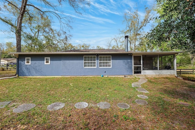 view of front of house featuring a front yard and a sunroom