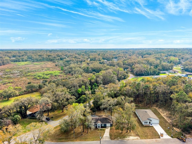 drone / aerial view with a wooded view