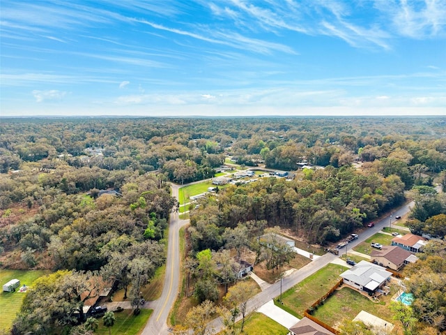 drone / aerial view featuring a forest view