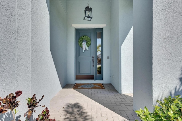 entrance to property with stucco siding