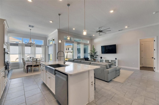 kitchen featuring visible vents, appliances with stainless steel finishes, a kitchen island with sink, a textured ceiling, and a sink