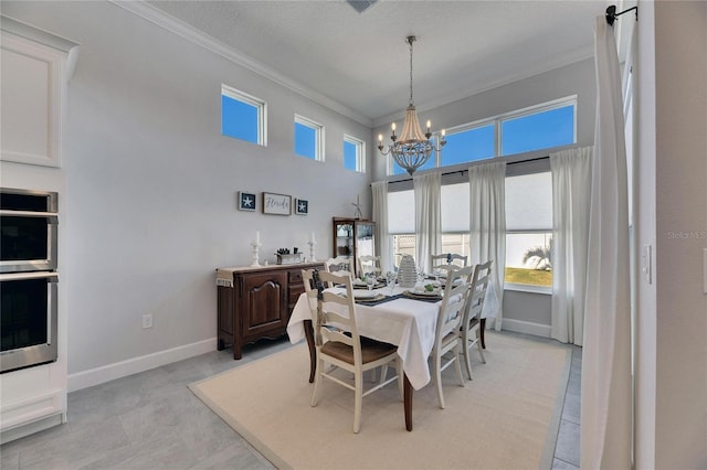 dining room with a notable chandelier, a textured ceiling, baseboards, and crown molding