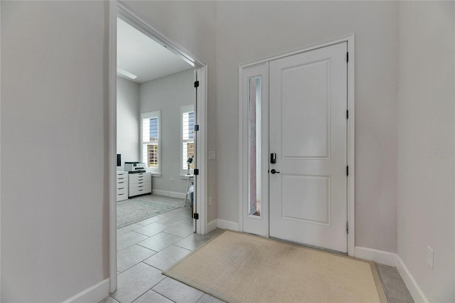 entryway featuring light tile patterned floors and baseboards