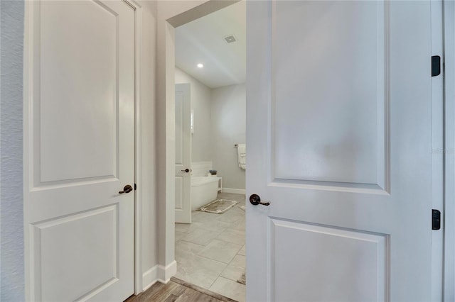 full bath with visible vents, wood finished floors, a bath, and baseboards