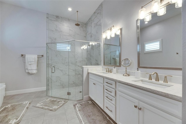 bathroom with baseboards, double vanity, a sink, and a shower stall