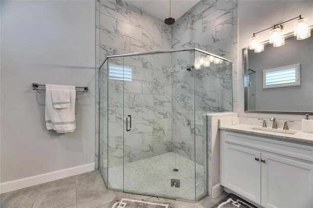 bathroom featuring a stall shower, vanity, and baseboards