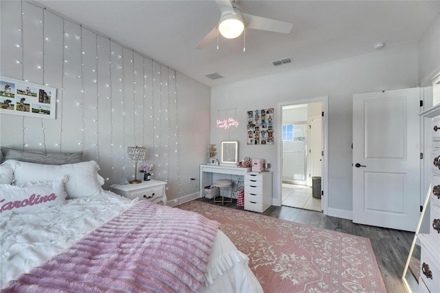 bedroom featuring ceiling fan, wood finished floors, visible vents, and baseboards