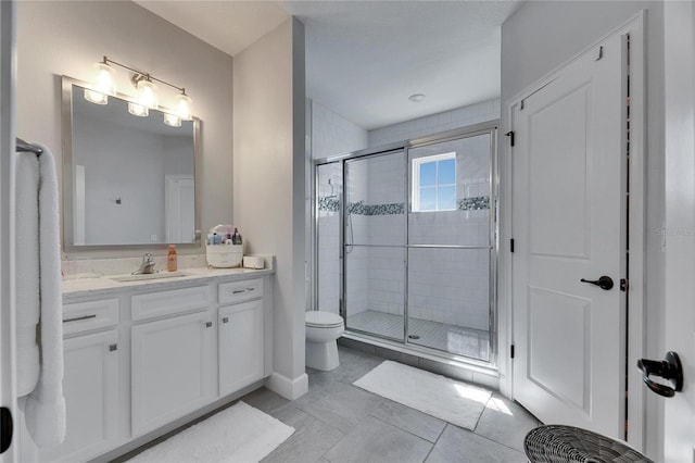 full bath featuring a stall shower, tile patterned flooring, vanity, and toilet