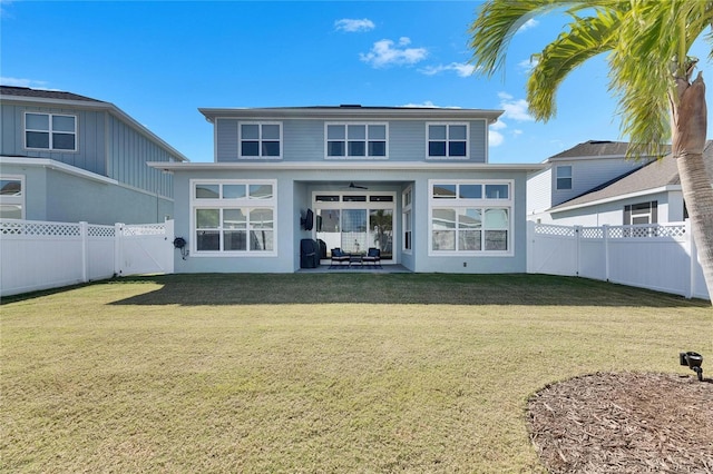 back of house featuring ceiling fan, a yard, a patio area, and a fenced backyard