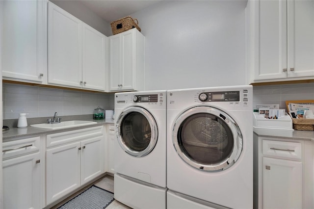 laundry area with a sink, cabinet space, and washer and dryer