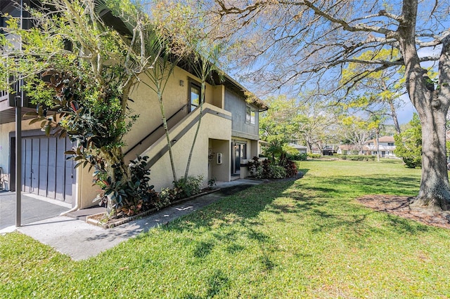 view of property exterior featuring stucco siding and a yard