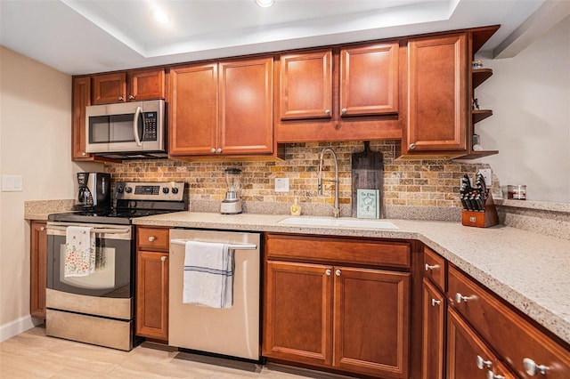 kitchen with open shelves, backsplash, stainless steel appliances, and a sink