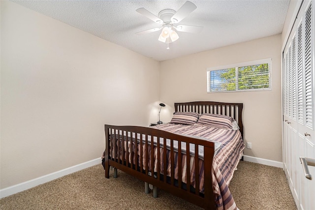 bedroom featuring carpet, baseboards, ceiling fan, and a textured ceiling