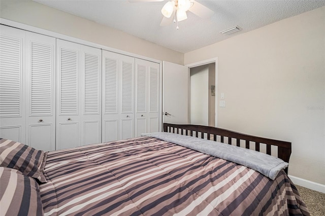 unfurnished bedroom featuring carpet floors, a closet, visible vents, a textured ceiling, and baseboards