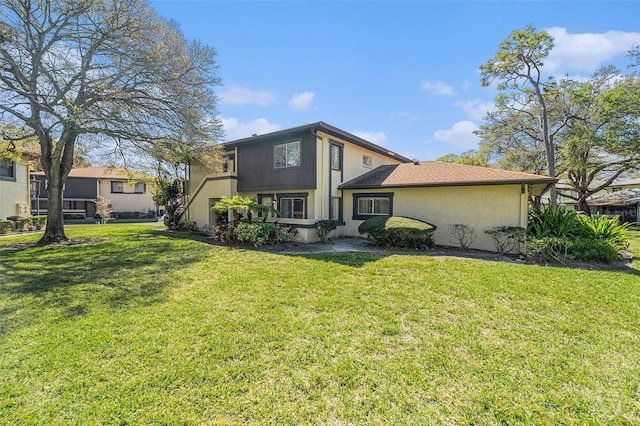 rear view of property with a yard