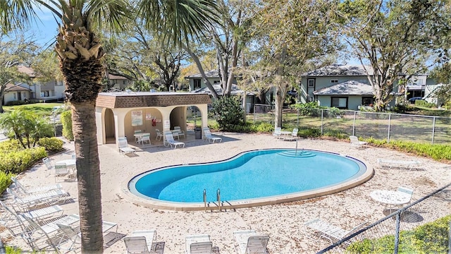 pool featuring a patio area and fence