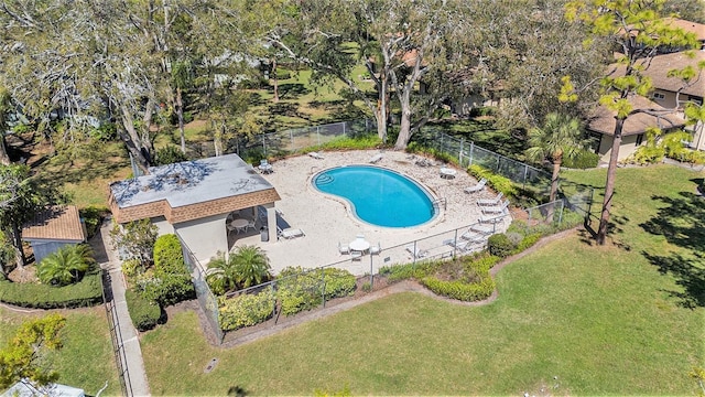 pool with a patio area, fence, and a lawn