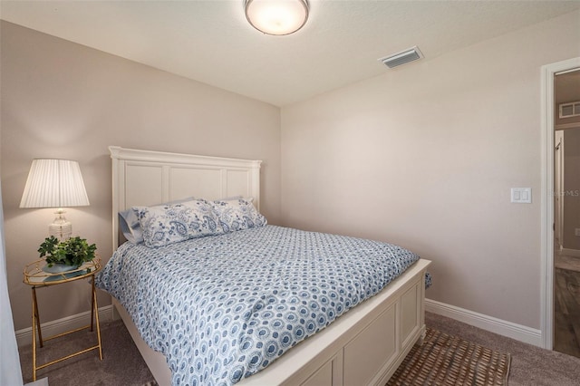 bedroom featuring dark carpet, visible vents, and baseboards