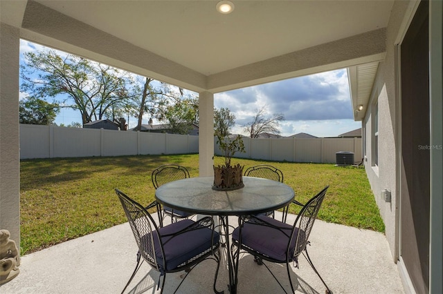 view of patio / terrace with a fenced backyard, central AC unit, and outdoor dining space