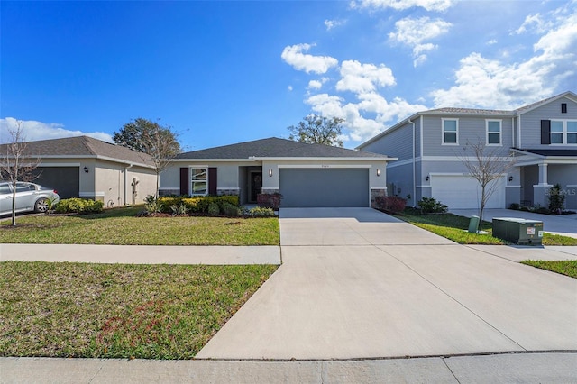 view of front of property featuring concrete driveway, a front lawn, and stucco siding