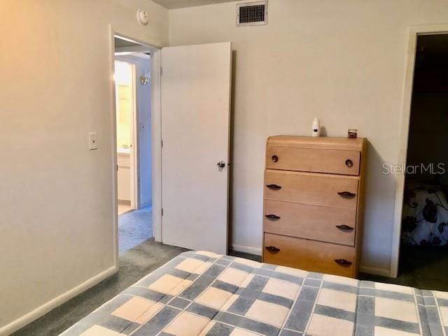 unfurnished bedroom with baseboards, visible vents, and carpet flooring