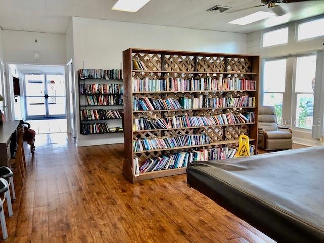 interior space with visible vents, wood finished floors, and pool table