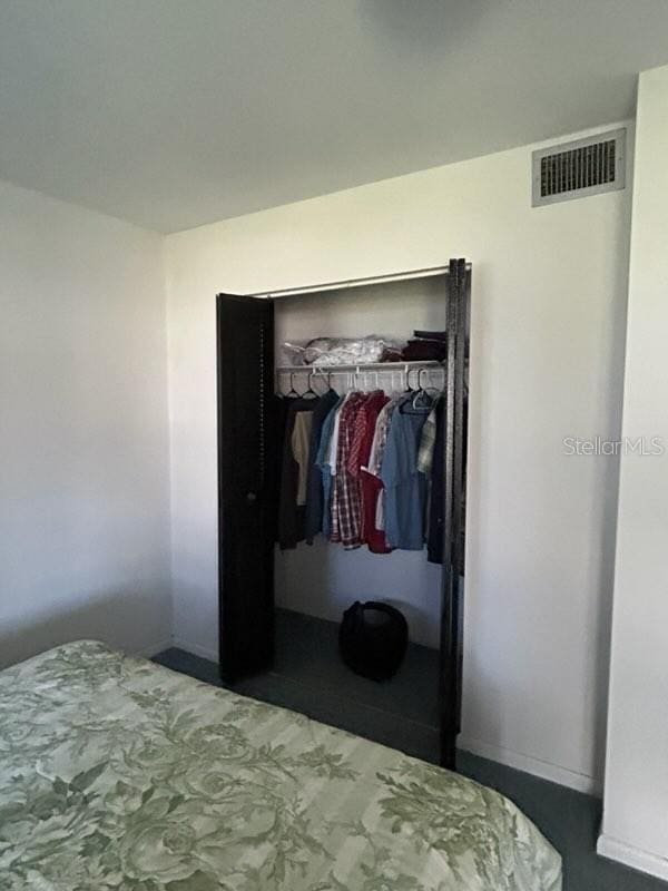 bedroom featuring a closet and visible vents