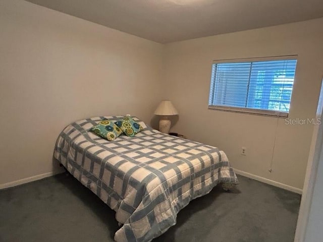 bedroom with carpet and baseboards