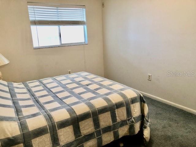 unfurnished bedroom with carpet floors and baseboards