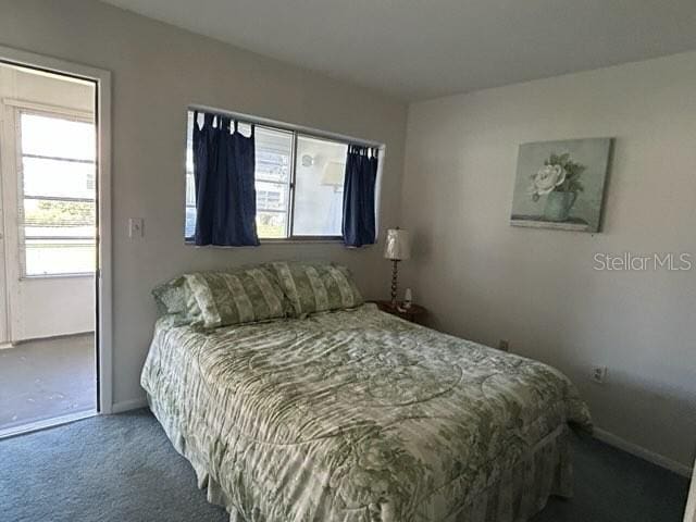 bedroom featuring carpet floors and baseboards