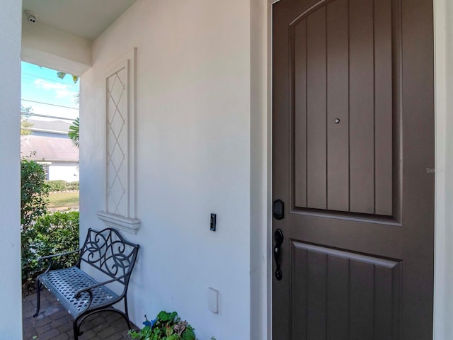 doorway to property with stucco siding