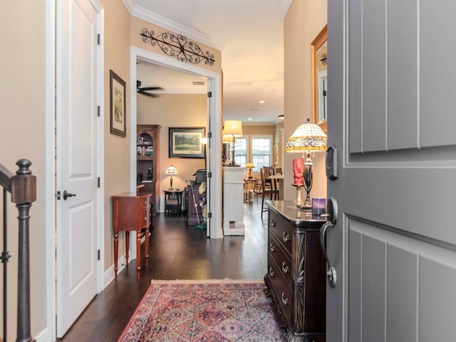 corridor featuring dark wood-style floors, stairway, and crown molding
