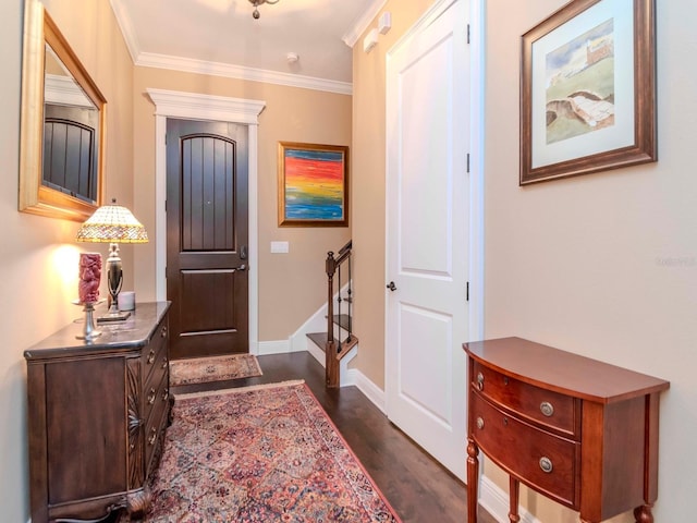 foyer featuring baseboards, stairway, dark wood finished floors, and crown molding