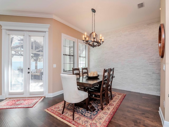 dining room with a healthy amount of sunlight, dark wood-style floors, visible vents, and crown molding