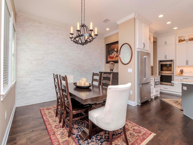 dining area featuring a chandelier, recessed lighting, dark wood-type flooring, baseboards, and ornamental molding