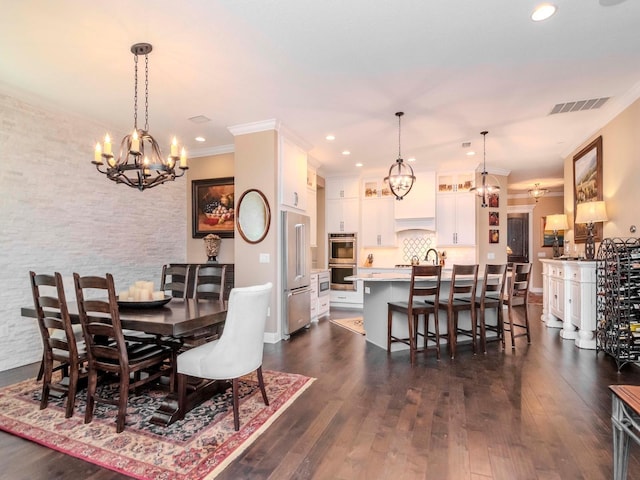 dining space with dark wood-style floors, visible vents, a notable chandelier, and ornamental molding