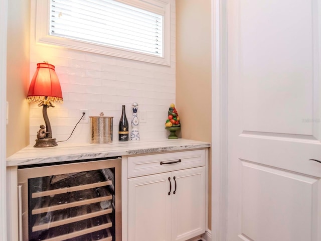 bar featuring a dry bar, wine cooler, and decorative backsplash