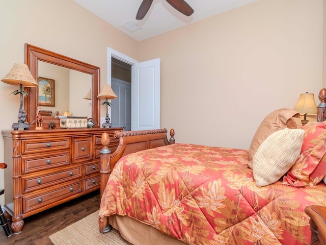 bedroom with dark wood-type flooring, visible vents, and a ceiling fan