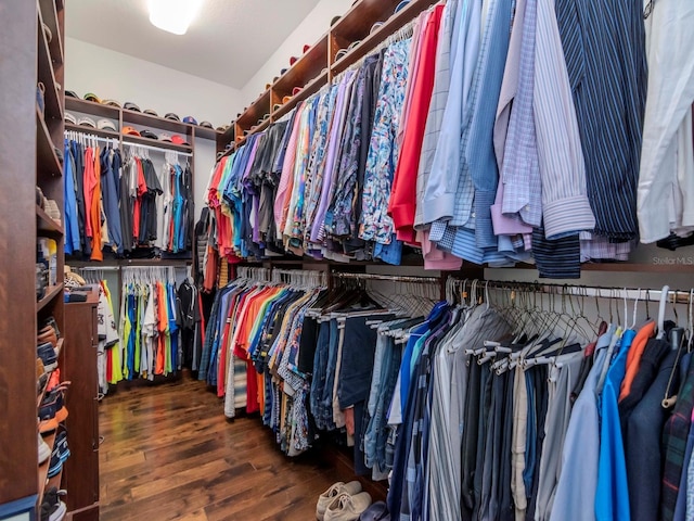 walk in closet with dark wood-type flooring