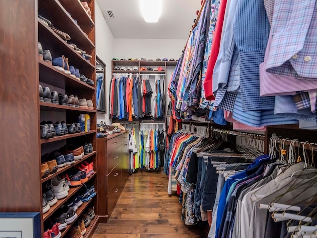 spacious closet with visible vents and dark wood finished floors
