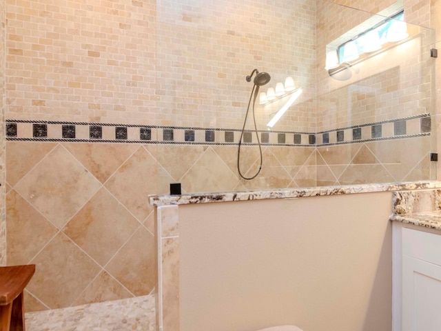 bathroom with walk in shower and vanity