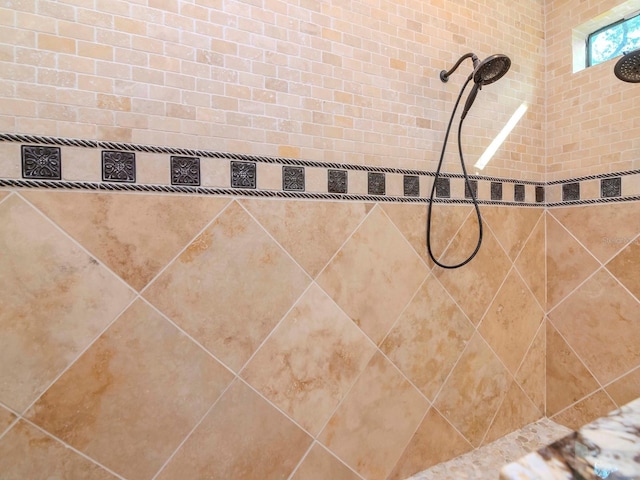 interior details with a tile shower