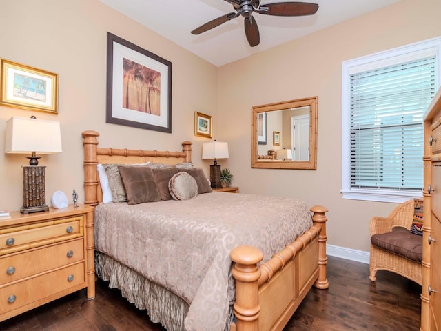 bedroom with a ceiling fan, baseboards, and dark wood-style flooring