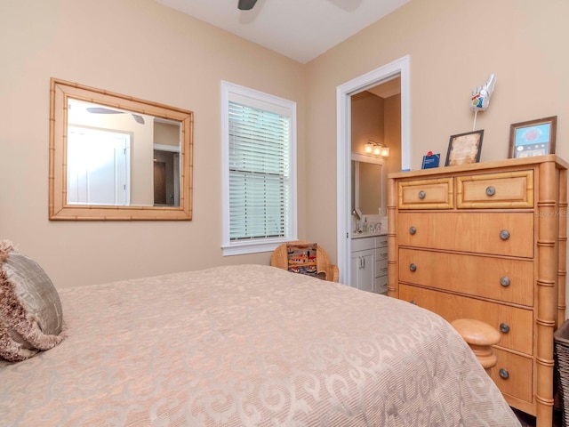 bedroom with ensuite bath and a ceiling fan