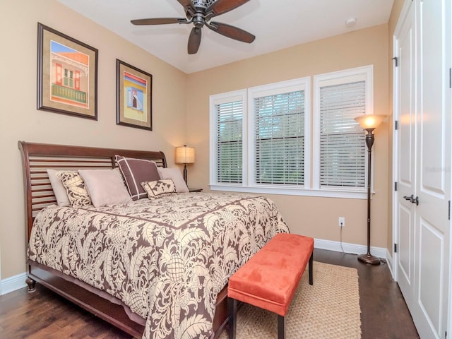 bedroom featuring ceiling fan, baseboards, and dark wood finished floors
