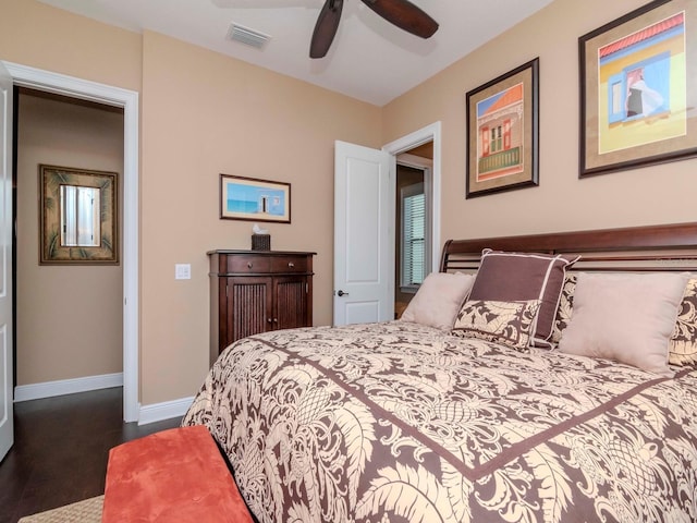bedroom featuring ceiling fan, dark wood-style flooring, visible vents, and baseboards