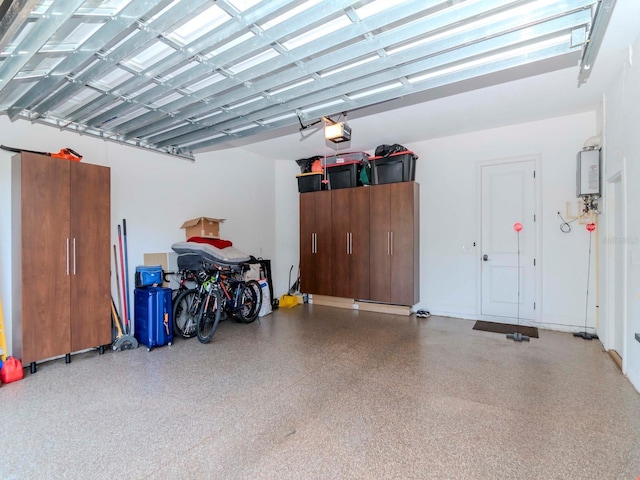 garage featuring tankless water heater and a garage door opener
