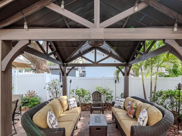 view of patio featuring a fenced backyard, outdoor lounge area, and a gazebo